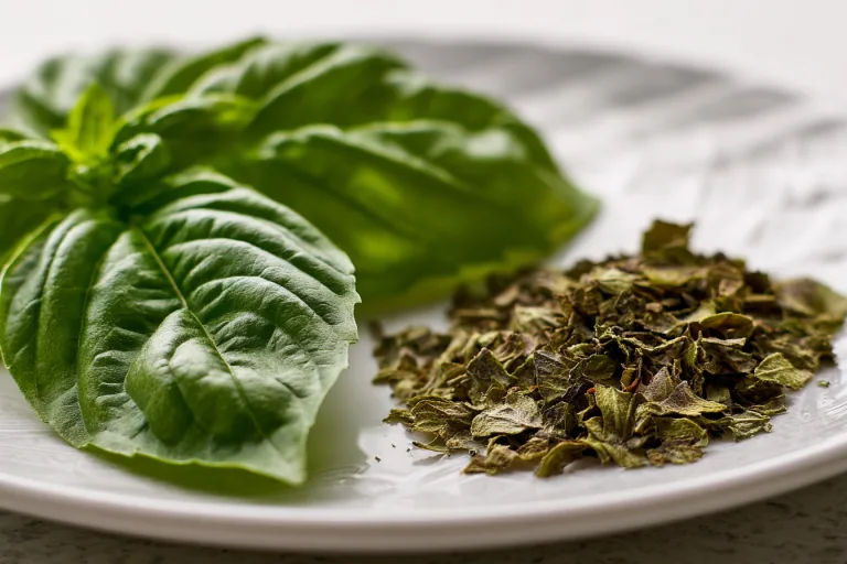 fresh green basil leaves and dried basil flakes side-by-side